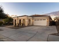 One-story home with a two-car garage and desert landscaping at 21004 E Sunset Dr, Queen Creek, AZ 85142