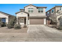 Two-story house with a two-car garage and desert landscaping at 35298 W San Ildefanso Ave, Maricopa, AZ 85138