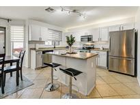 Modern kitchen with island, stainless steel appliances, and granite countertops at 40136 N Costa Del Sol Dr, San Tan Valley, AZ 85140