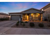 Charming single-story home with neutral gray exterior, brick driveway, manicured landscape, and covered porch at 4752 S Orbit Ave, Mesa, AZ 85212