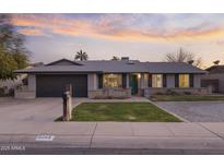 Charming single-story home with a well-maintained front yard and attached two-car garage at 5045 W Mescal St, Glendale, AZ 85304