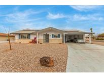 Ranch style home with carport, solar panels, and landscaped yard at 6252 E Billings St, Mesa, AZ 85205