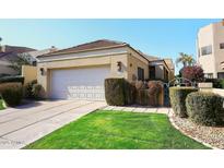 Single-story home with attached garage and well-manicured lawn at 7740 E Gainey Ranch Rd # 13, Scottsdale, AZ 85258