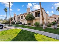 Two-story condo building with lush landscaping and palm trees at 9708 E Via Linda -- # 2313, Scottsdale, AZ 85258