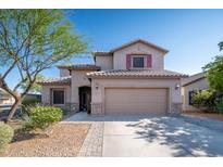 Two-story house with a beige exterior, two-car garage, and landscaping at 10789 W Yearling Rd, Peoria, AZ 85383