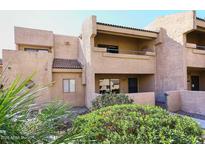 Two-story stucco condo with private entrance and landscaping at 10828 N Biltmore Dr # 115, Phoenix, AZ 85029