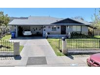 Ranch style home with attached garage and landscaped yard at 1109 E Caldwell St, Phoenix, AZ 85042