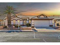 Single-story home with a two-car garage and desert landscaping at 14949 W Robson Cir, Goodyear, AZ 85395