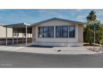 Single-wide manufactured home with carport and paved driveway at 17200 W Bell Rd # 1581, Surprise, AZ 85374