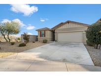 Single-story house with a two-car garage and desert landscaping at 17923 W Louise Dr, Surprise, AZ 85387