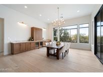 Elegant dining room features a large table, chandelier, and built-in cabinetry at 19910 N 84Th St, Scottsdale, AZ 85255