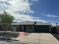 Charming single-story home with a well-maintained front yard and a paved walkway, features a two-car garage at 2331 W Onza Ave, Mesa, AZ 85202