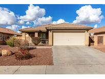 One-story house with beige exterior, attached garage, and landscaped front yard at 25700 W St James Ave, Buckeye, AZ 85326