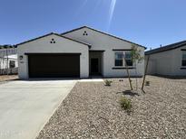 Charming single-story home with a low-maintenance desert landscape and a two car garage at 46905 W Old Timer Rd, Maricopa, AZ 85139