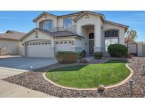 Two-story house with a three-car garage and landscaped front yard at 6023 W Kimberly Way, Glendale, AZ 85308