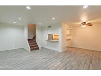 Spacious living room with tile floors and kitchen bar at 8446 N 34Th Dr, Phoenix, AZ 85051