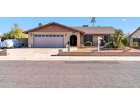 Ranch style home with a two-car garage and well-manicured landscaping at 9469 N 50Th Dr, Glendale, AZ 85302