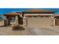 Single-story home with a two-car garage and neutral color palette at 10036 W Parkway Rd, Tolleson, AZ 85353