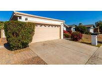 House exterior showcasing a garage and well-manicured landscaping at 10436 W Devonshire Ave, Phoenix, AZ 85037