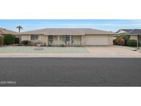 Ranch style home with attached garage and well-manicured lawn at 10737 W Hutton Dr, Sun City, AZ 85351