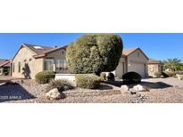 Single-story home with desert landscaping and two-car garage at 18328 N Avalon Ln, Surprise, AZ 85374