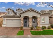 Two-story house with stone accents, and a three-car garage at 2485 S Quaintance St, Gilbert, AZ 85295