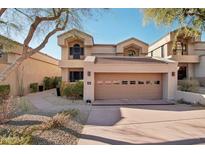 Two-story townhome with attached garage and landscaped walkway at 25150 N Windy Walk Dr # 11, Scottsdale, AZ 85255