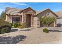 Single-story home with stone accents and a two-car garage at 29874 N Little Leaf Dr, San Tan Valley, AZ 85143