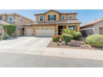 Two-story home featuring a three-car garage, desert landscaping, and a classic-style facade at 3501 E Apricot Ln, Gilbert, AZ 85298