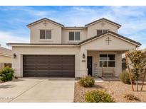 Two-story house with a brown garage door and landscaped front yard at 36582 N Lincoln Red Rd, San Tan Valley, AZ 85143