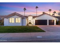 Stunning curb appeal featuring a two-car garage and well-manicured lawn at 5720 E Marilyn Rd, Scottsdale, AZ 85254