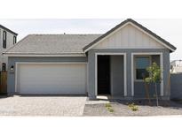 Gray exterior boasts a modern design, two-car garage, and well-manicured landscaping at 5830 S Daisy Patch Pl, Phoenix, AZ 85040