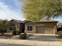 Single-story house with a two-car garage and desert landscaping at 7668 E Thunderhawk Rd, Scottsdale, AZ 85255