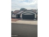 Charming single-story home with a well-manicured front yard and a two-car garage in a quiet residential neighborhood at 7685 W San Miguel Ave, Glendale, AZ 85303