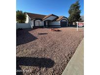 Single story home with rock landscaping and a fire pit at 7685 W San Miguel Ave, Glendale, AZ 85303