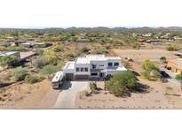 Expansive desert estate featuring modern architecture, multiple garages, and adjacent horse property at 817 E Irvine Rd, Desert Hills, AZ 85086