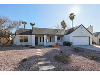 White single story home with a two car garage and nicely landscaped front yard at 1025 E Kerry Ln, Phoenix, AZ 85024