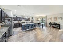 Spacious open-concept kitchen featuring a large center island and a modern dining area at 13235 W Tether Trl, Peoria, AZ 85383