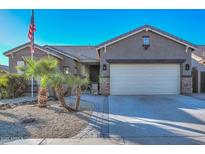 One-story house with desert landscaping, large driveway, and three-car garage at 16351 W Yucatan Dr, Surprise, AZ 85388