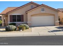 One-story house with tan exterior, tile roof, and landscaped front yard at 17449 N Fairway Dr, Surprise, AZ 85374