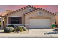 Charming single-story home with a two-car garage, low-maintenance landscaping, and a tile roof at 17449 N Fairway Dr, Surprise, AZ 85374