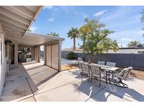 Covered patio with outdoor dining set and pool access at 1865 W Keating Ave, Mesa, AZ 85202