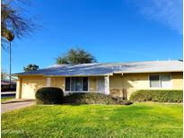 Ranch style home with well-manicured lawn and attached garage at 19002 N Signal Butte Cir, Sun City, AZ 85373