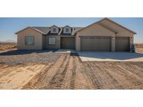 New construction home with two-car garage and desert landscaping at 2383 E Cana Ln, Casa Grande, AZ 85194