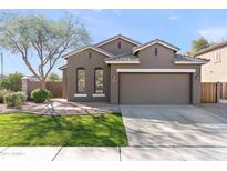 Charming single-story home with a well-manicured lawn and a two car garage at 3471 E Powell Way, Gilbert, AZ 85298