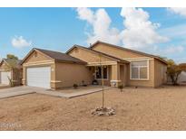 Single story home with a white garage door and desert landscaping at 3640 W Melinda Ln, Glendale, AZ 85308