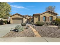 Charming home with a well-manicured, low-maintenance front yard and a stone walkway at 40325 N Graham Way, Anthem, AZ 85086