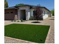 Charming single-story home featuring a modern design and well-manicured landscaping with artificial grass at 4201 N 18Th Pl, Phoenix, AZ 85016
