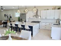 Bright modern kitchen features a large center island, stainless steel appliances, and white cabinetry at 4201 N 18Th Pl, Phoenix, AZ 85016