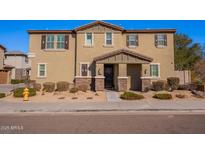 Two-story house with light brown exterior, stone accents, and a landscaped front yard at 5172 E Desert Forest Trl, Cave Creek, AZ 85331